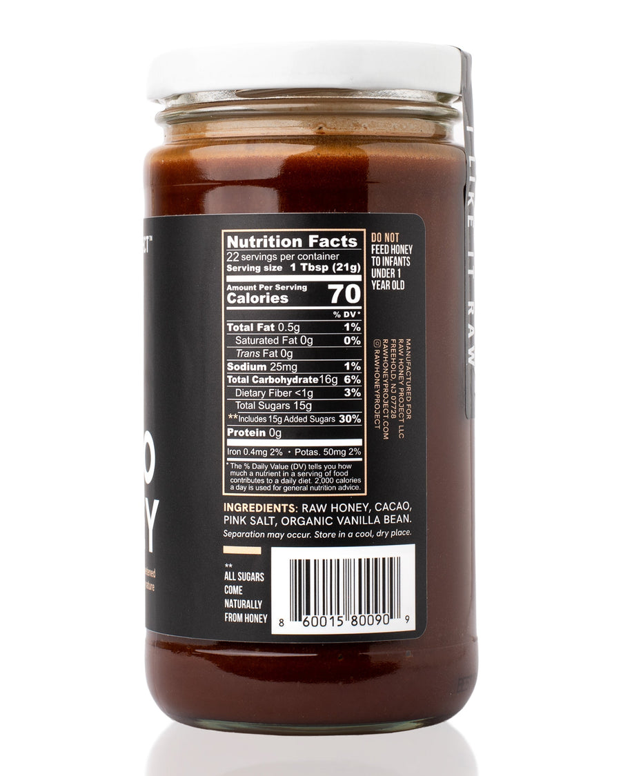 Nutrition and ingredients panel of Raw Honey Project Cacao Honey jar with a black label, showing Nutrition Facts, ingredient list, and barcode.