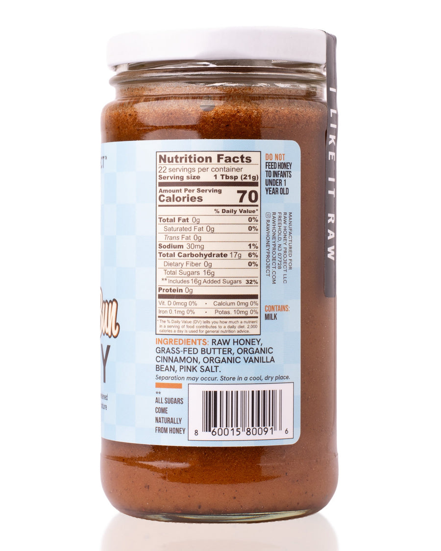 Primary (recommended):
Nutrition and ingredients panel of Raw Honey Project Cinnamon Bun Honey jar, showing Nutrition Facts, ingredient list, allergen info, and barcode.