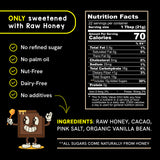 Nutrition panel and ingredient information for Raw Honey Project Cacao Honey. The image states ‘Only sweetened with raw honey’ and lists features: no refined sugar, no palm oil, nut-free, dairy-free, and no additives. Nutrition Facts show 22 servings per container, serving size 1 tablespoon (21 grams), 70 calories per serving, total fat 0.5g, sodium 25mg, total carbohydrate 16g, total sugars 15g including 15g added sugars, protein 0g, iron 0.4mg, and potassium 50mg. Ingredients: raw honey, cacao, pink salt,