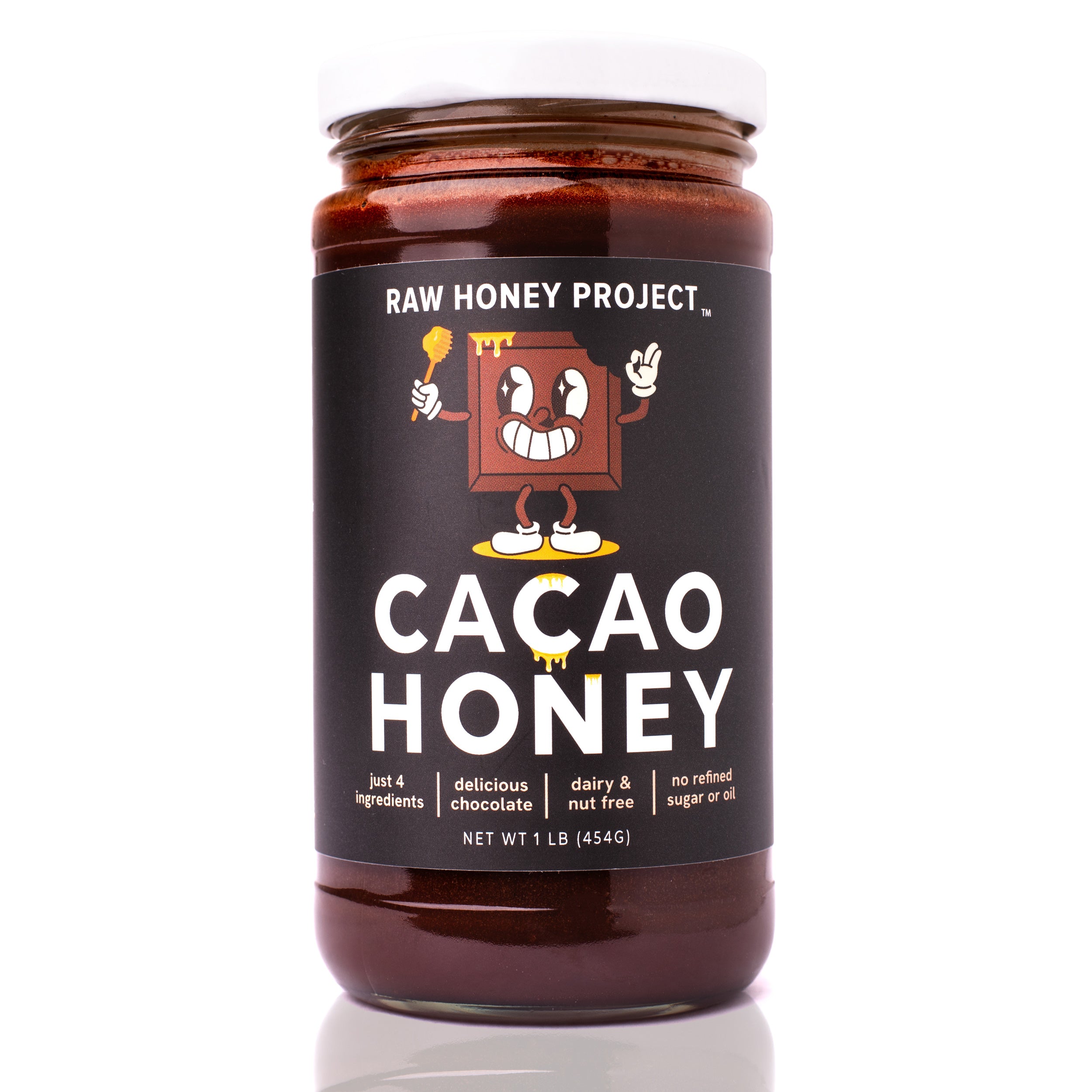 Raw Honey Project Cacao Honey jar front label — one pound of chocolate-infused raw honey made with four real ingredients: raw honey, cacao, organic vanilla bean, and pink salt. Label reads ‘delicious chocolate,’ ‘dairy and nut free,’ and ‘no refined sugar or oil.’
