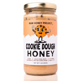 Raw Honey Project Cookie Dough Honey jar front view with gold lid and illustrated cookie mascot on label.